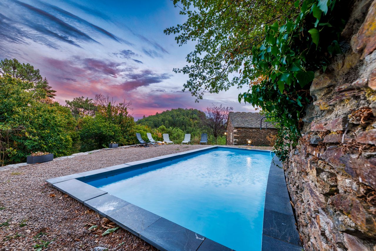Seconde piscine du domaine au coucher du soleil, ciel rose au-dessus des Cévennes